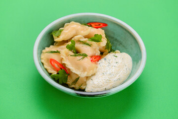 Ukrainian dish Vareniki, ukrainian dumplings, pierogi with sauce - traditional Ukrainian food.