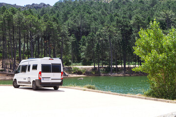 camper van on a road near a lake in the mountains of sardinia
