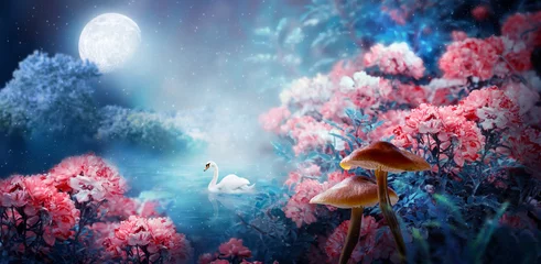 Foto op Plexiglas Fantasy Magical Enchanted Fairy Tale Landscape With Swan Swimming In Lake, Fabulous Fairytale Blooming Pink Rose Flower Garden And Mushrooms On Mysterious Blue Background And Glowing Moon Ray In Night © julia_arda