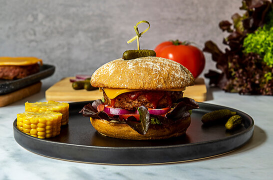 Beyond Burger With Vegan Cheese, Corns, Onion, And Pickles.