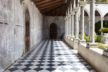 walkway path with checkered pattern marble tiles floor and shadow from outside sunlight in old gothic church