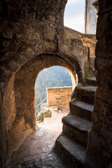 Steps inside the tower with access to a cliff in front of a mountain valley in the medieval town of Calcata in Italy depopulated in 1930th for fear of collapse and then partially repopulated in 1960th
