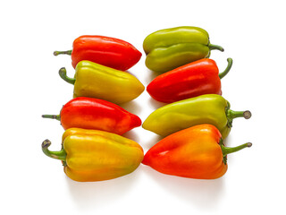 Crop of fresh yellow-green and red peppers isolated on a white