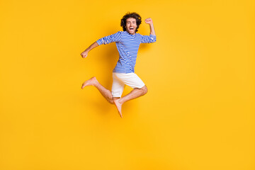 Fototapeta na wymiar Full size profile side photo of crazy middle eastern guy jump run fast isolated over bright yellow color background