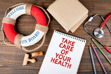 TAKE CARE OF YOUR HEALTH. Red stethoscope, stationery and lifebuoy with text