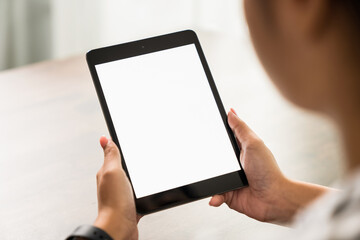 Young woman holding digital tablet with a blank screen on table, for putting advertising to promote.