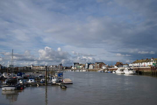 Dramatic stormy skies over the River Arun in Littlehampton with cumulus clouds.