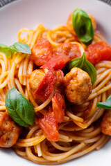 Spaghetti with meatballs, salad and tomatoes, italian pasta