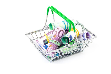 Close-up of a shopping cart full of euro and dollar bills, isolated on a white background. The...