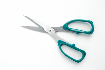 Green scissors isolated on a white background.