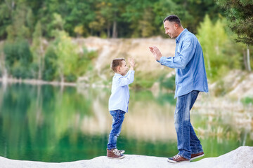 A Happy parent with child on nature in park travel