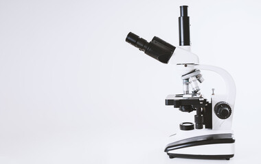 Using a biological microscope. Close up of a microscope. Scientific research concept, using a microscope. Medical examinations, searching for bacteria, diseases, blood tests.