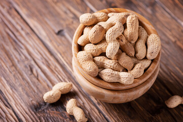  Roasted peanuts in wooden bowl