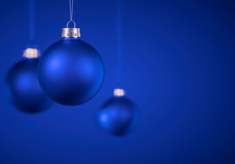 Light blue round matt Christmas ball. Christmas ornament standing on blue background.