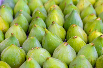 Row of vibrant green fresh ripe figs at the local market. Image with selective focus