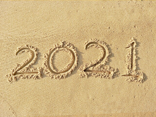 2021 text writing on the beach sand