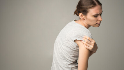 Fototapeta premium Tired woman feeling pain, massaging tense muscles