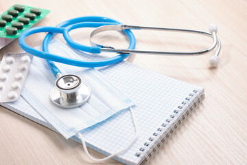 medicines, pills, medical stethoscope and notepad for notes, disease diagnosis concept