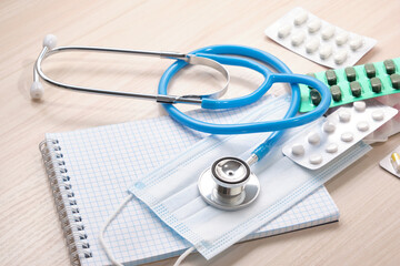 medicines, pills, medical stethoscope and notepad for notes, disease diagnosis concept