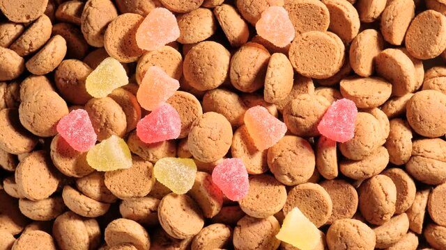 Saint nicholas is throwing traditional cookies for Dutch holiday Sinterklaas. Kruidnoten, sweets, strooigoed. St. Nicolas day concept. 4K video, 50 fps