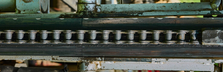 Abstract, detailed view of the conveyor chain for tools on an old machine