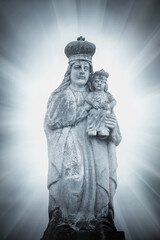Very ancient stone statue of Queen of Heaven with baby Jesus Christ
