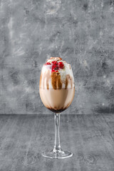 Glass of cold coffee drink with whipped cream and cherry