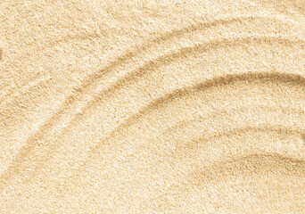 Wavy beige sand texture background close up