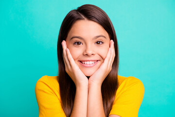 Fototapeta premium Photo portrait of cute girl resting head on two hands isolated on bright turquoise colored background