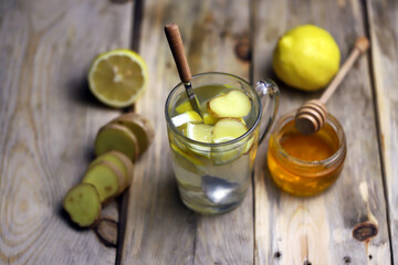 Hot ginger-lemon drink in a mug. on a wooden surface. Folk remedies for colds. Antiviral products. Selective focus. Macro.