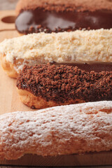 French eclairs. Chocolate and cream eclairs for coffee. Sweets for a coffee break