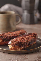 French eclairs. Chocolate and cream eclairs for coffee. Sweets for a coffee break