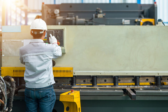 Worker operate hydraulic press brake bending machine in construction factory