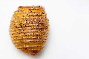 Baked hasselback potato on a white background