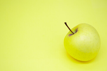 A large green Golden Apple in the lower right corner on a green background. Cope space