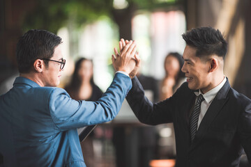 Young business people shaking hands in the office, Finishing successful meeting, handshake of business people deal business