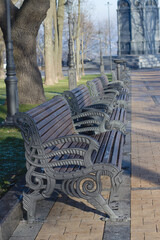 Wooden benches with metal railing in the park.