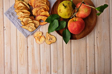 Organic Apple chips (slices) on a white background is a healthy vegetarian fruit snack or cooking ingredient. The concept is a healthy