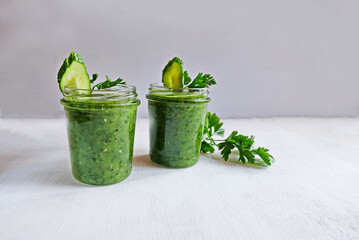 Green cocktail of spinach, lemon, cucumber and parsley on a light background. The concept of healthy nutrition, detox, green, diet, vegan, keto, fit