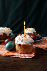 Traditional Orthodox Easter bread the kulich, russian kitchen, religion, painted eggs, candle. Food photo.