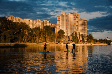 group of people floating on sup boards on the river