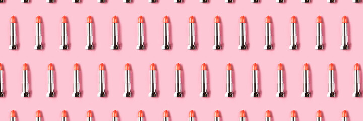 Obraz premium Banner made from lipsticks on pink background.