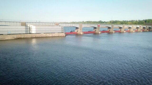 Drone view of  the dike and moveable portion of the dam of Lock and Dam 14 on the Mississippi River consisting of tainter and 4 roller gates; Lock and Dam 14 on the Register of Historic Sites;