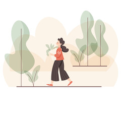 A young woman walks through the Park with purchases
