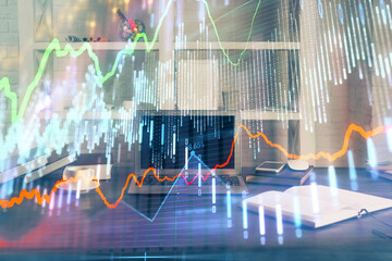 Financial market graph hologram and personal computer on background. Double exposure. Concept of forex.