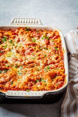Traditional Italian baked lasagne with meat and cheese in the dish. Italian cuisine concept.