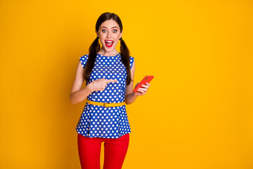 Look i found social media promo. Excited crazy girl use smartphone point index finger indicate...