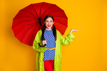 Portrait of positive cheerful girl enjoy spring walk hold red parasol hand feel imagined raindrops wear good look clothes isolated over bright shine color background