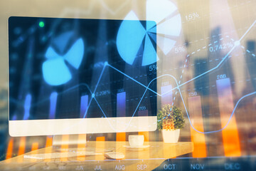 Forex market graph hologram and personal computer on background. Double exposure. Concept of investment.