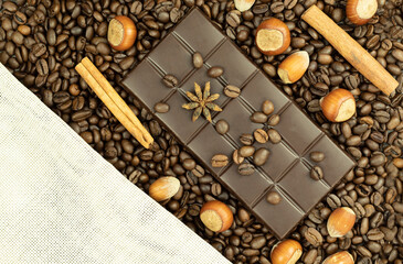 Chocolate bar and cinnamon on coffee beans